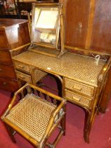 A contemporary bamboo and cane kneehole dressing table, with swing mirror and matching stool,