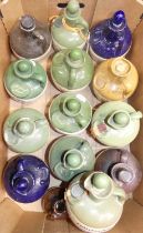 Six fruit trays containing a collection of whisky related stoneware advertising flagons, to