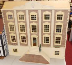 A child's mock Georgian town house, four tier dolls house with hinged double front, opening to