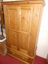 A modern pine double door wardrobe, having single long lower drawer, width 110cm Height 194cm.