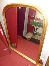 A contemporary mounded gilt framed arched over mantel mirror in the Victorian taste, 138.5 x 135cm