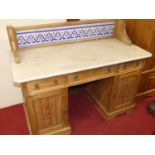 A Victorian ash white marble topped and tile backed kneehole wash stand, having three frieze drawers