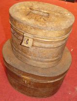 Two early 20th century painted metal oval hinge topped hat boxes, the larger w.42cm