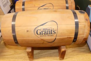 Three coopered and metal bound whisky barrels for William Grant's on integral stands, with taps,