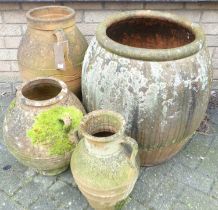 Four various terracotta planters, the largest of ovoid form, height 63cm All are heavily weathered