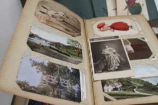 An early 20th century postcard album and contents, to include floral examples; together with three