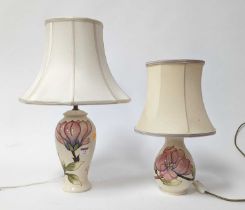 A Moorcroft pottery Magnolia pattern table lamp, h.53cm (including shade); together with another