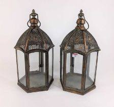 A pair of patinated metal hexagonal hanging lanterns, height 48cm