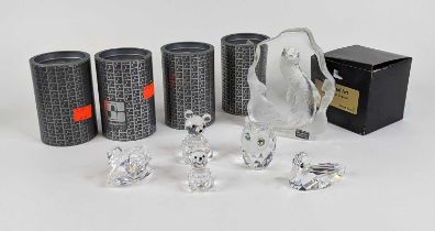 A collection of four Swarovski crystal animals, together with a Mats Jonasson lead crystal