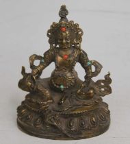 A gilt metal figure of a deity, with inset hardstone decoration, h.13cm