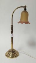 An adjustable brass table lamp, having a coloured glass shade, h.58cm