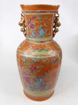 A Chinese Canton porcelain vase, enamel decorated with birds amongst flowers on an orange ground,