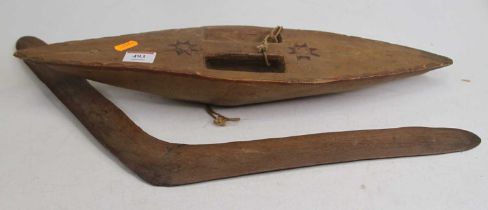 An Aboriginal carved hardwood boomerang, 54cm; together with a carved hardwood shield, h.47cm