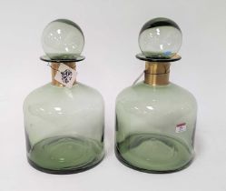 A pair of modern green glass bottles, each having a brushed brass collar, h.37cm