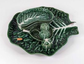 A Portugese majolica serving dish in the form of a cabbage leaf, together with a set of four