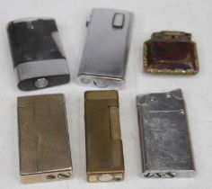 A collection of cigarette lighters to include Dunhill gilt metal example, having all-over engine