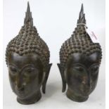 A pair of bronzed Buddha heads, h.28cm