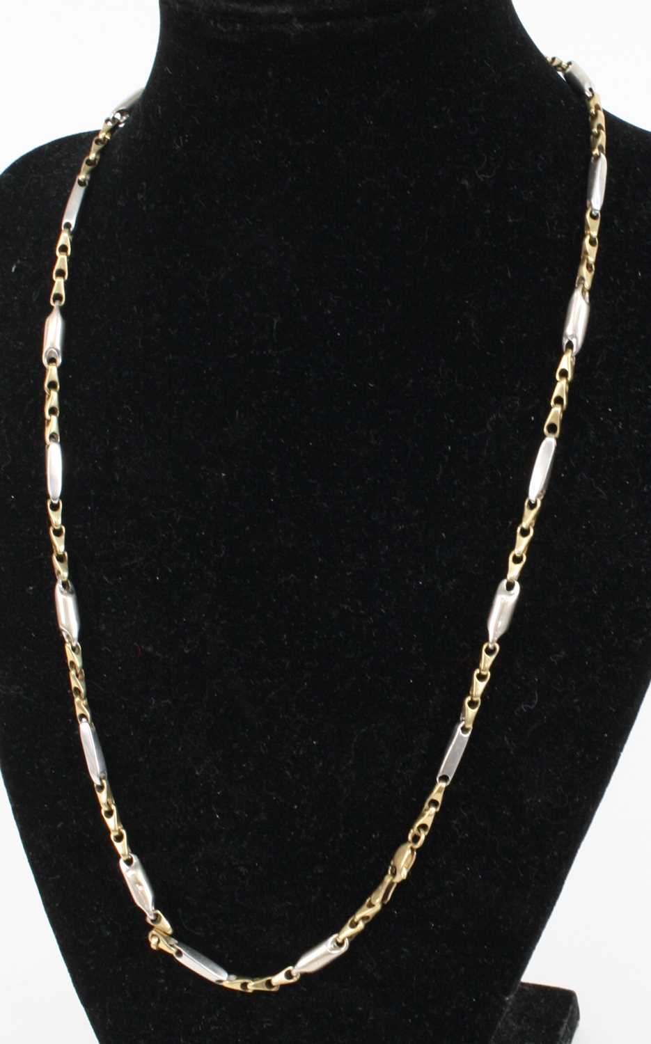 A contemporary 9ct yellow and white gold necklace, 17.6g, 50cm Slight play to the clasp and doesn’