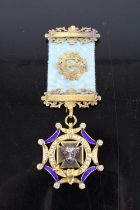A silver gilt enamel and paste set Masonic jewel, with bar, by L Simpson & Co of London, in original