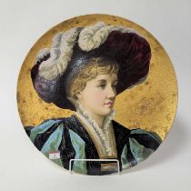 A Wedgwood pottery charger, decorated with a lady, overpainted, dia.47cm The face and hat has been