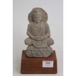 A Tibetan figure of a seated deity, on a later hardwood plinth, h.18cm