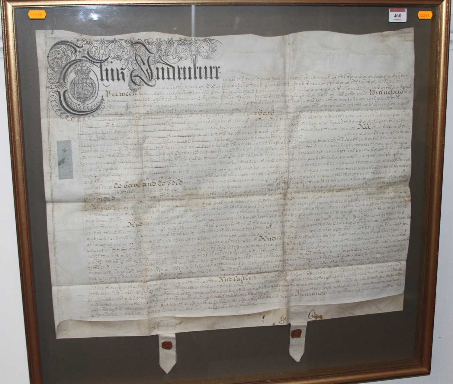 An early 18th century handwritten indenture dated 1704, in a glazed frame, indenture measures