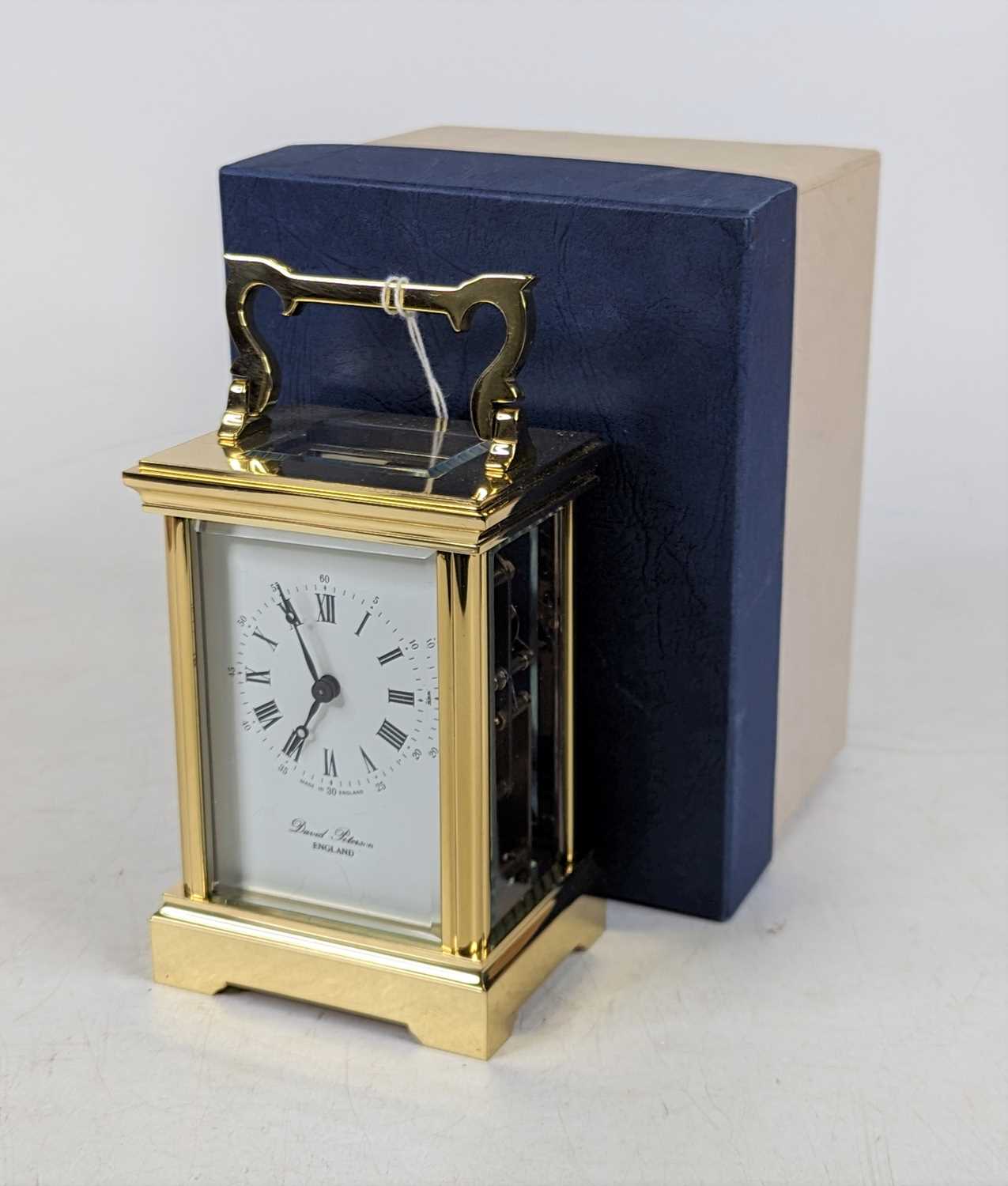 A David Peterson brass carriage clock, the dial showing Roman numerals, having visible platform