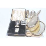 A collection of silver to inlcude tea strainer, caddy spoon, part christening set, and silver clad