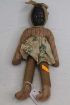 An early 20th century doll, having a painted face, fabric body and limbs, 29cm