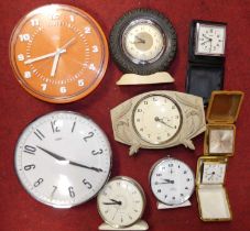 A mid-20th century Smith's Tinecal orange plastic wall clock, having applied Arabic markers and