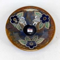 A Royal Doulton stoneware bowl, decorated with flowers, numbered 20097, dia.28cm Firing damage to