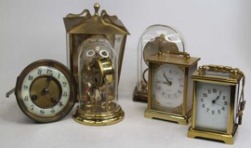 A 20th century German anniversary clock, under perspex dome, h.15cm; together with another, two