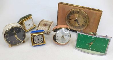 A collection of vintage mantel and travel clocks