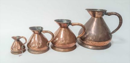 Four 19th century copper measures, the largest h.31cm, the smallest 12cm
