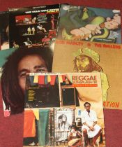 A collection oif vintage LP's to include Bob Marley, Elvis and Jim Reeves, housed in three plastic