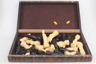 A resin chess set in the medieval style, height of king 11.5cm, together with fold-over chessboard