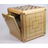 A 20th century maple games compendium of cuboid form, each surface having a different game board,