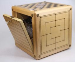 A 20th century maple games compendium of cuboid form, each surface having a different game board,