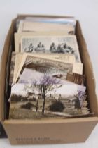 A collection of late 19th/early 20th century postcards, primarily topographical views and satirical