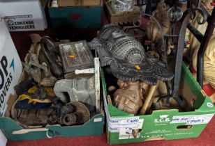 Two boxes of miscellaneous items, to include wood carvings and a wrought iron table candlestick