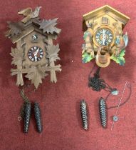 Two Swiss wooden cuckoo clocks