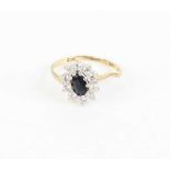 A modern 9ct gold, blue and white sapphire set flower head cluster ring, 1.6g, size L