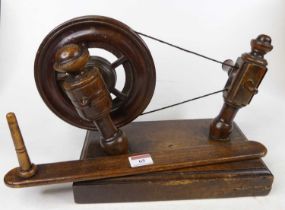 A 19th century provincial fruitwood spinning wheel, w.34cm