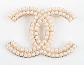After Coco Chanel - a gilt metal faux pearl set brooch, w.55mm