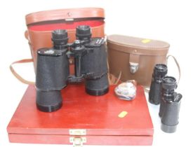 A pair of Revue 10x50 binoculars, cased; together with another pair; and a rifle cleaning set (3)