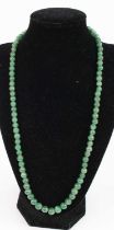 A beaded nephrite necklace, 58cm; together with a pair of vintage carved jade ear pendants on 14ct