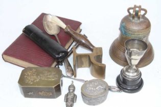 A Victorian brass novelty inkwell in the form of a bell, having a hinged lid, impressed design