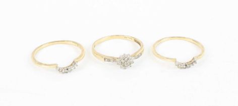A matching set of three 9ct gold and diamond point set rings, having centre flower head cluster
