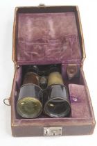 A pair of vintage brass game binoculars, cased