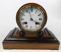 A 19th century walnut and ebonised mantel clock of drum head shape, the enameled dial signed JW